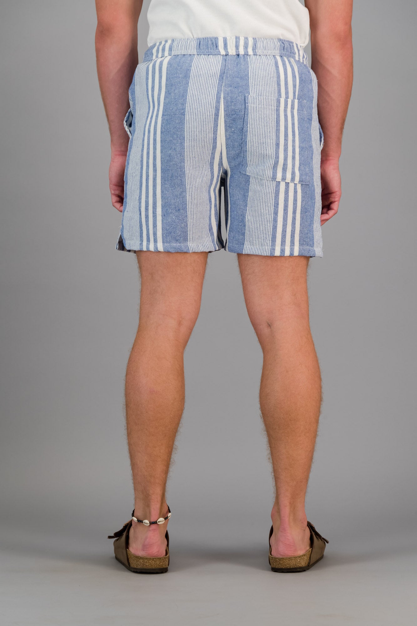 Model wearing blue striped cotton kikoi shorts.