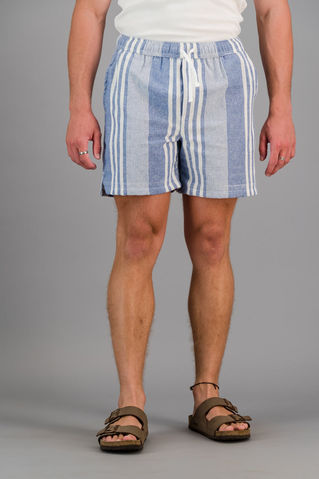 Model wearing blue striped cotton kikoi shorts.