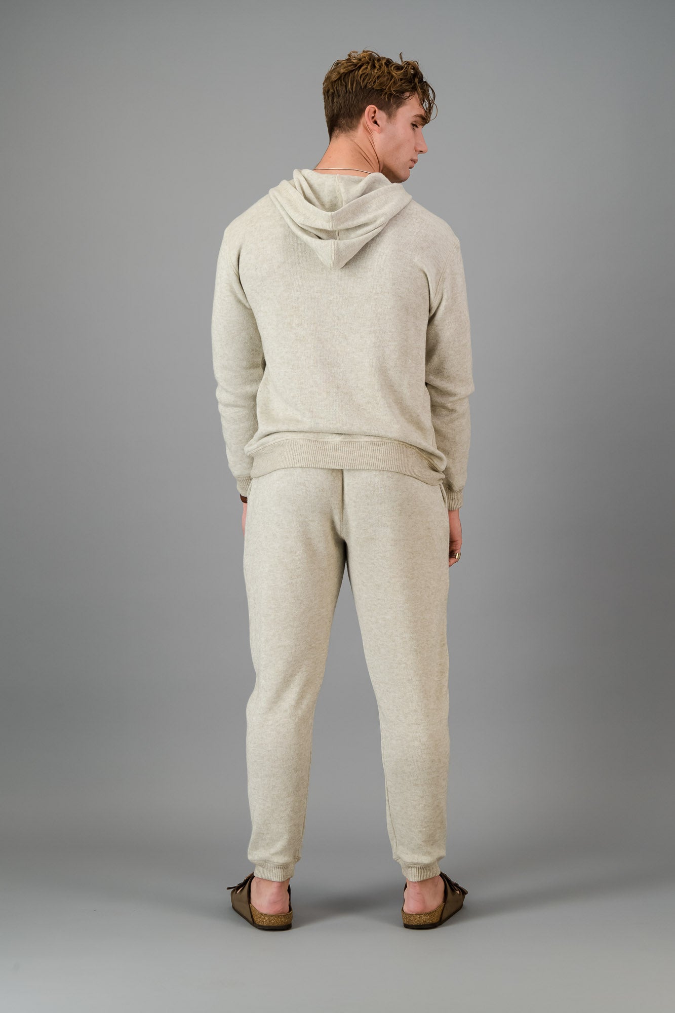 A man in an Oatmeal Cashmere-Feel Hoodie and matching joggers.