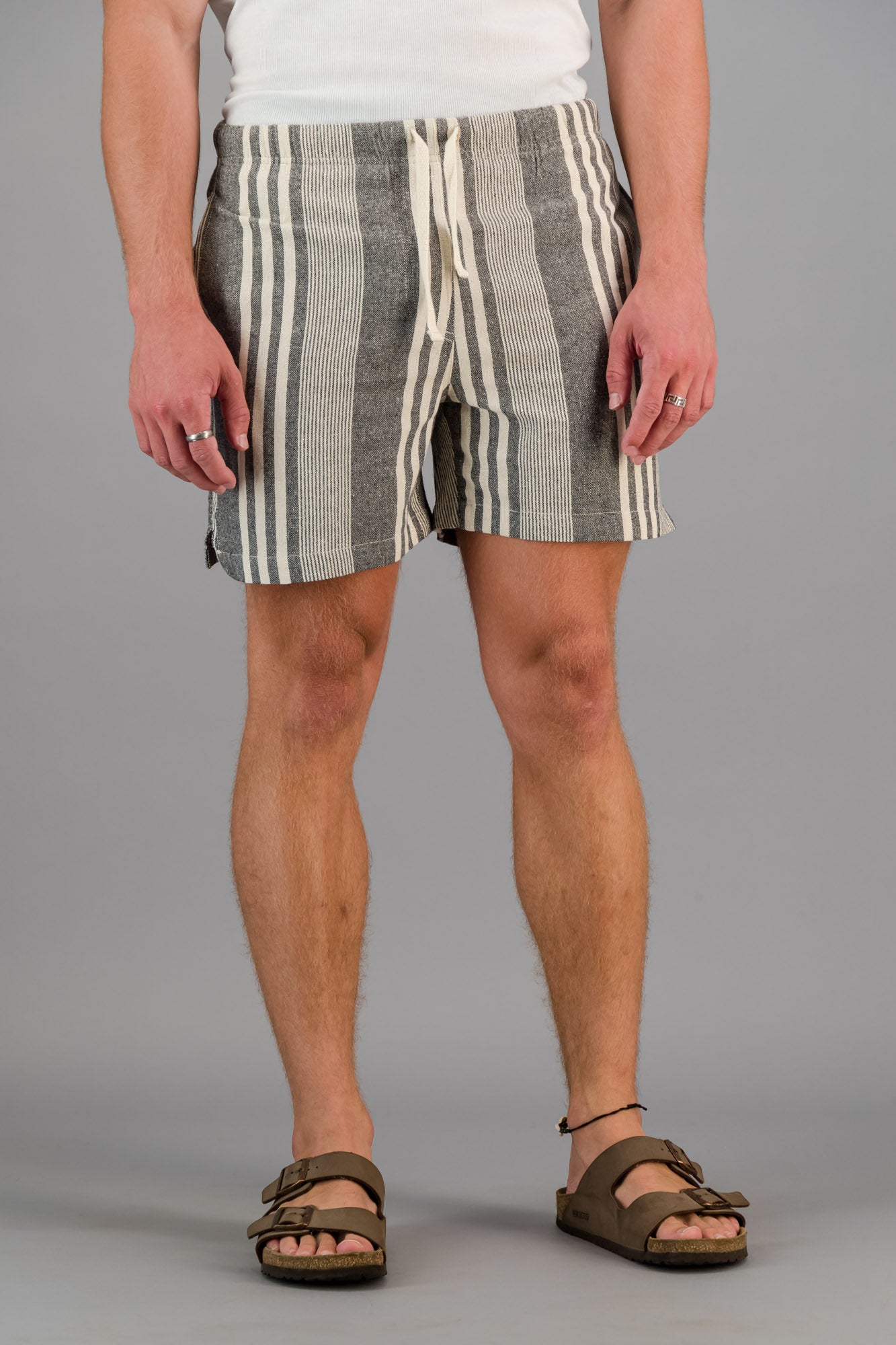 Model wearing charcoal striped cotton kikoi shorts.