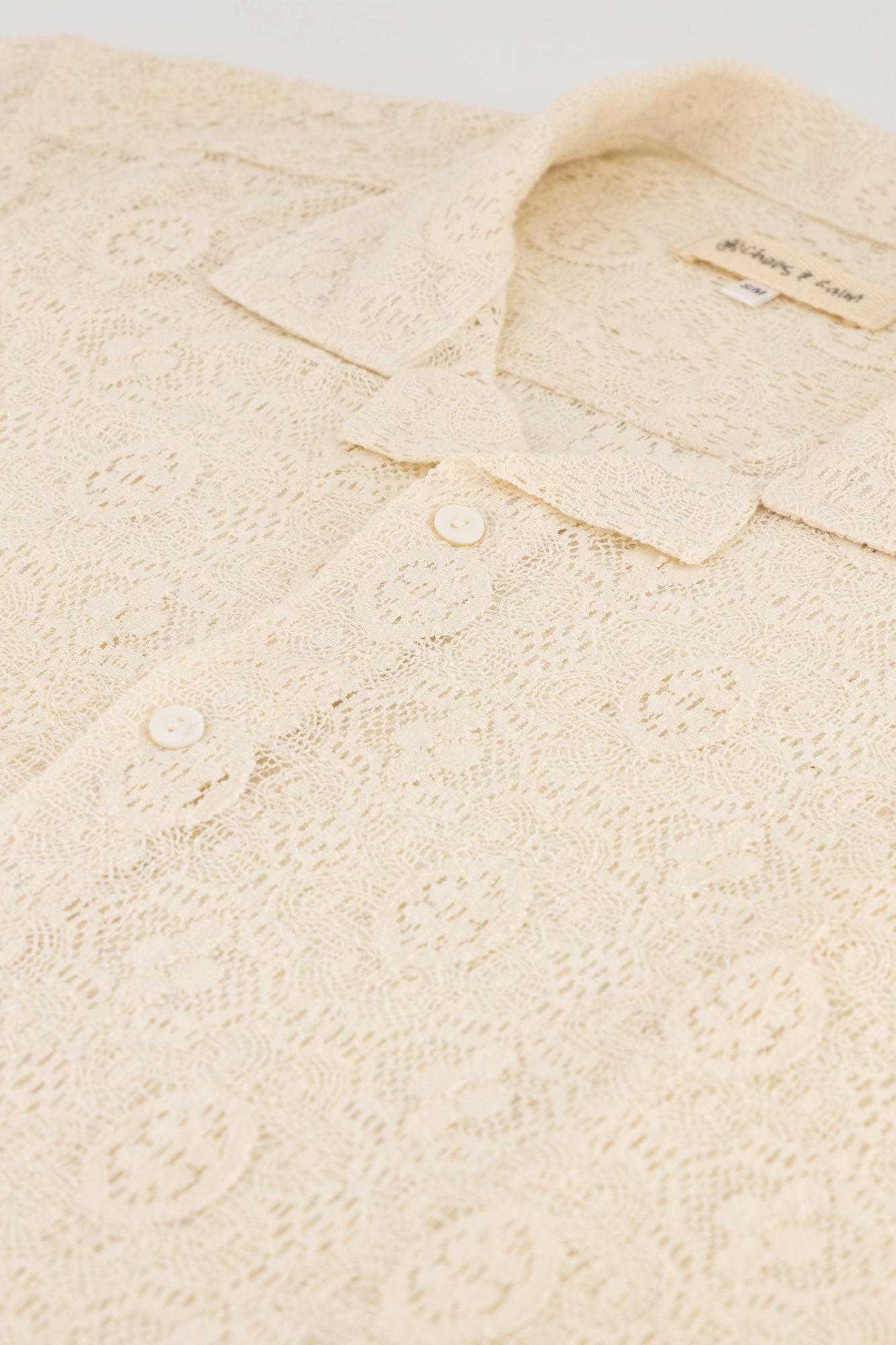 Flat-lay shot of short-sleeve Cotton Lace Shirt Milk.