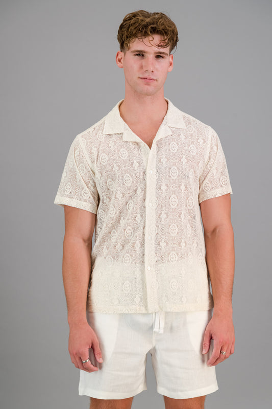 A man wearing a short-sleeve Cotton Lace Shirt in Milk colour.