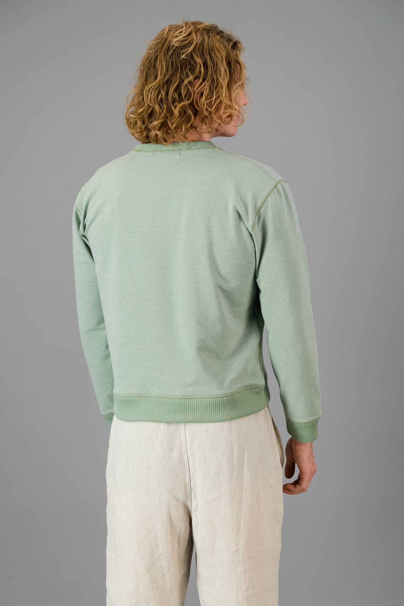 Model wearing Cotton Sweater Sage Green (Cut-Off).