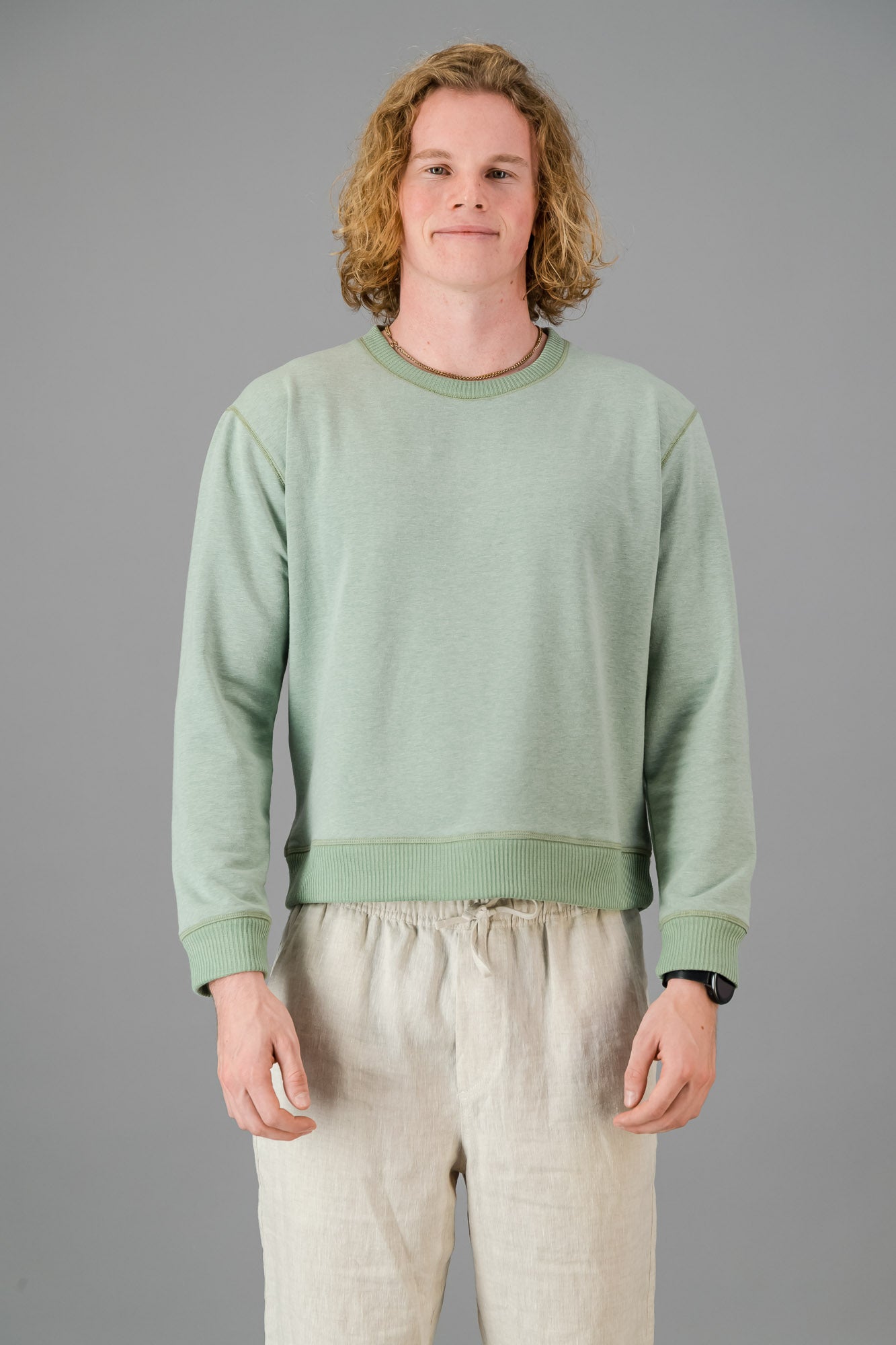 Model wearing Cotton Sweater Sage Green (Cut-Off).