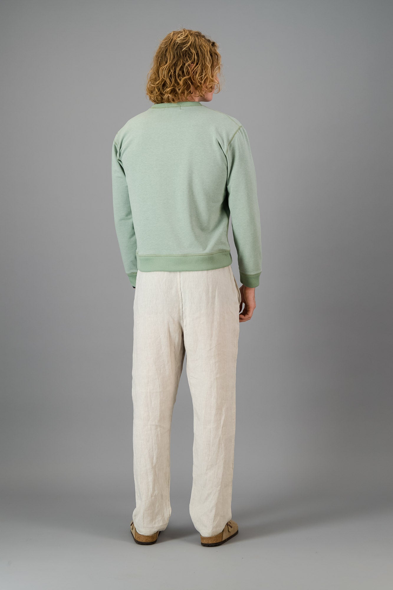 Model wearing Cotton Sweater Sage Green (Cut-Off).