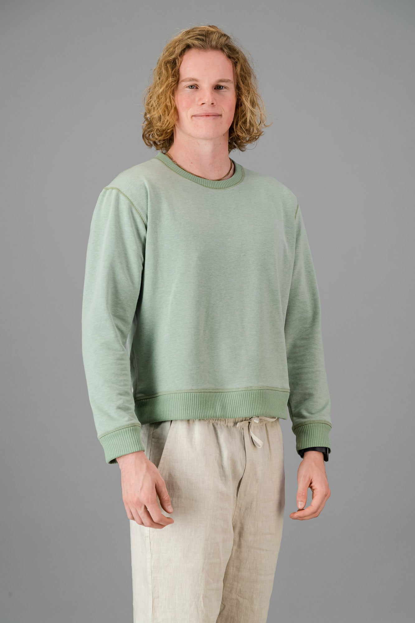 Model wearing Cotton Sweater Sage Green (Cut-Off).